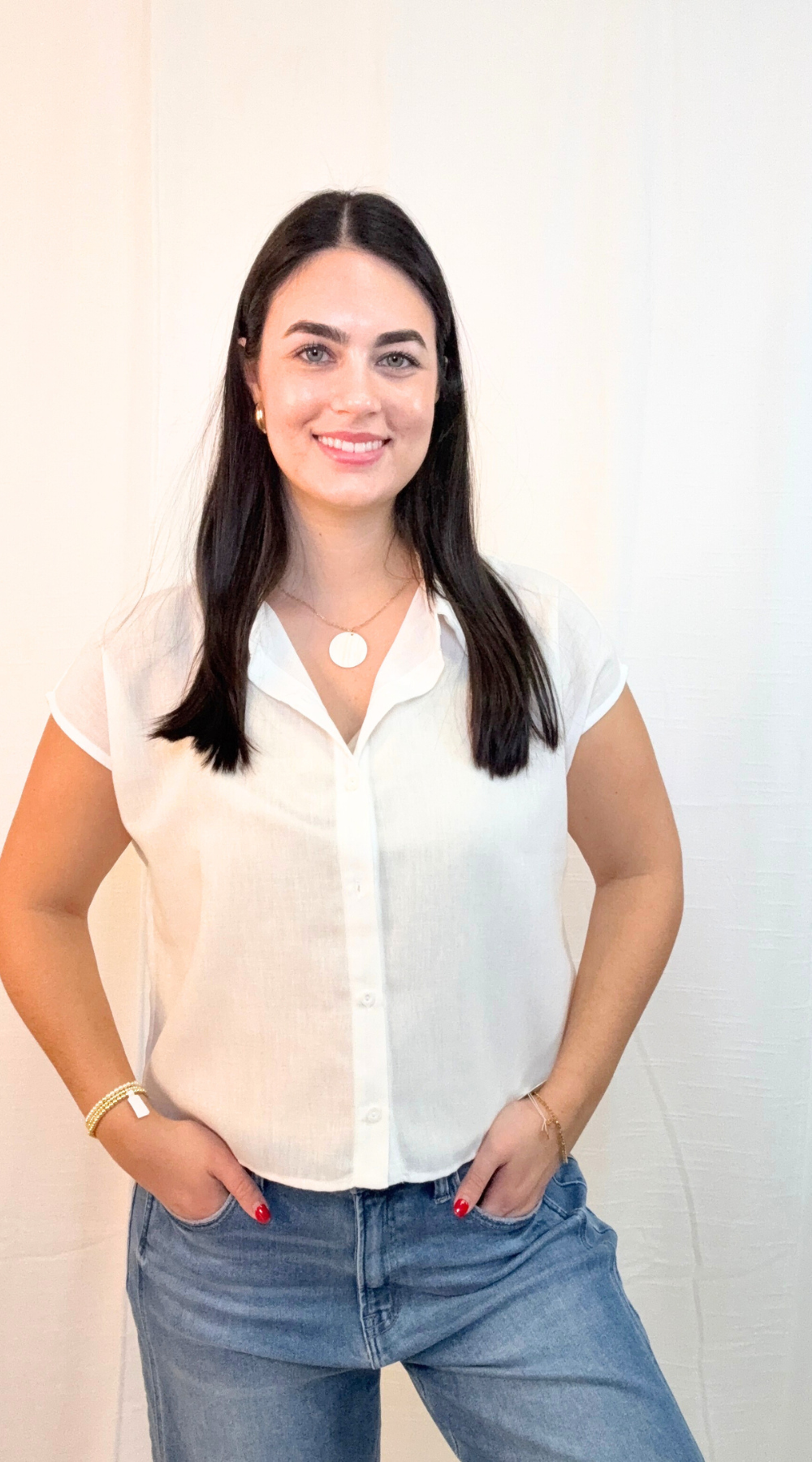 White short sleeve button-up top with lightweight fabric and relaxed fit