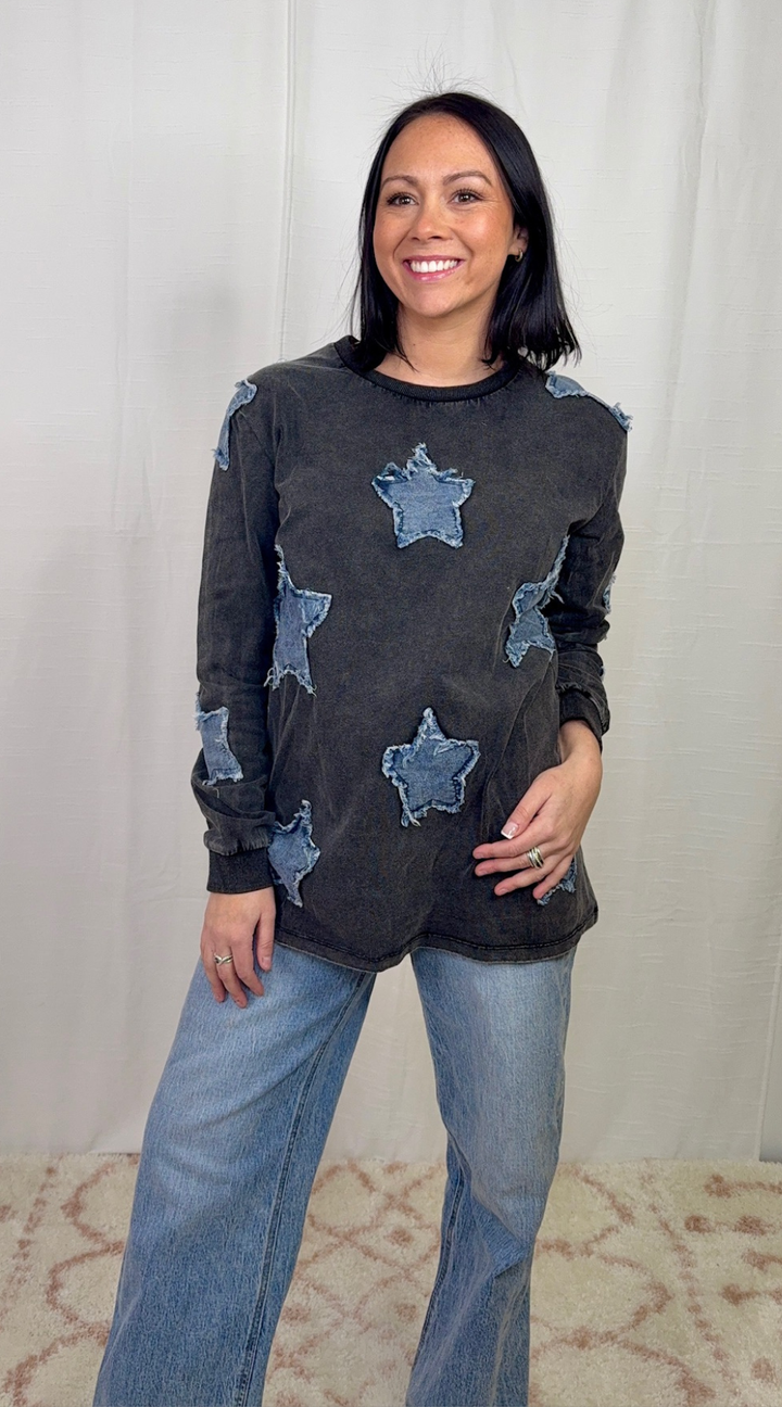 Charcoal long sleeve top with star appliqué detail worn with blue jeans