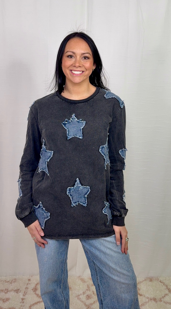 Charcoal long sleeve top with star appliqué detail worn with blue jeans