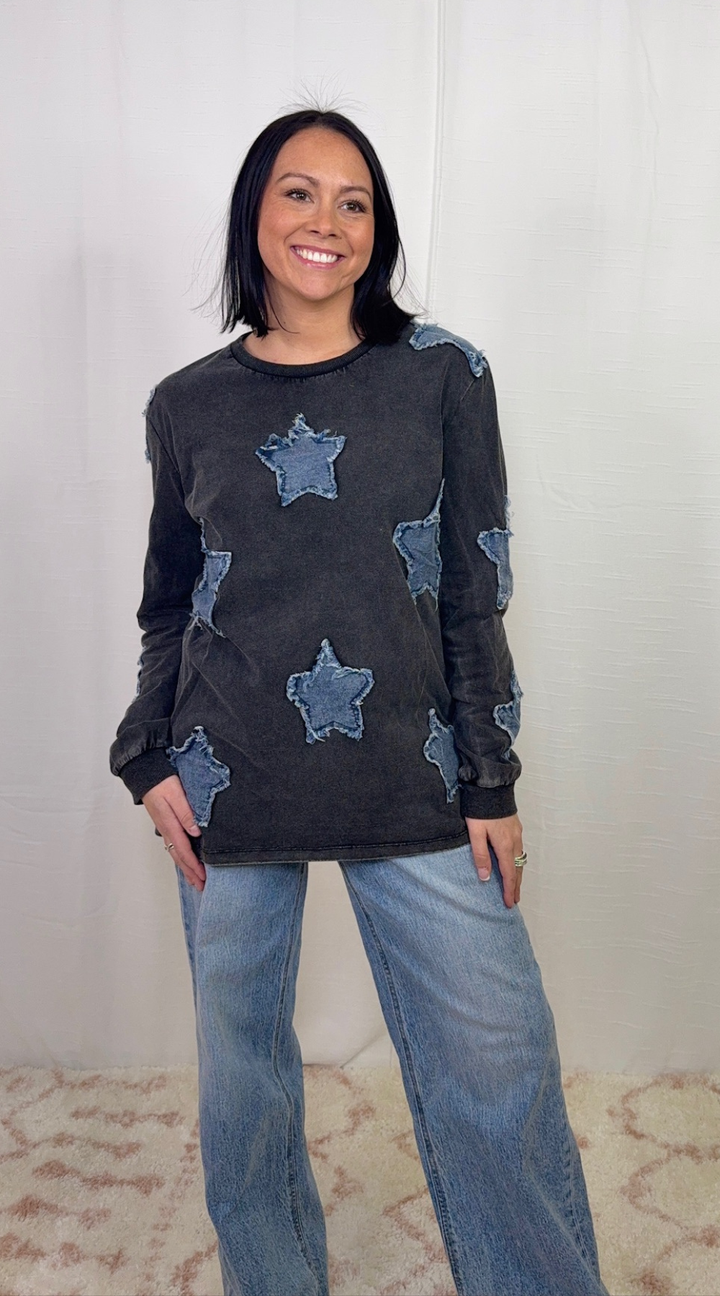 Charcoal long sleeve top with star appliqué detail worn with blue jeans