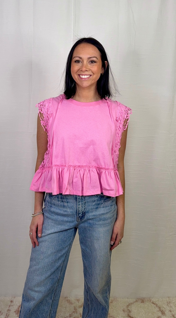 Pink ruffle hem sleeveless cotton top worn with blue jeans