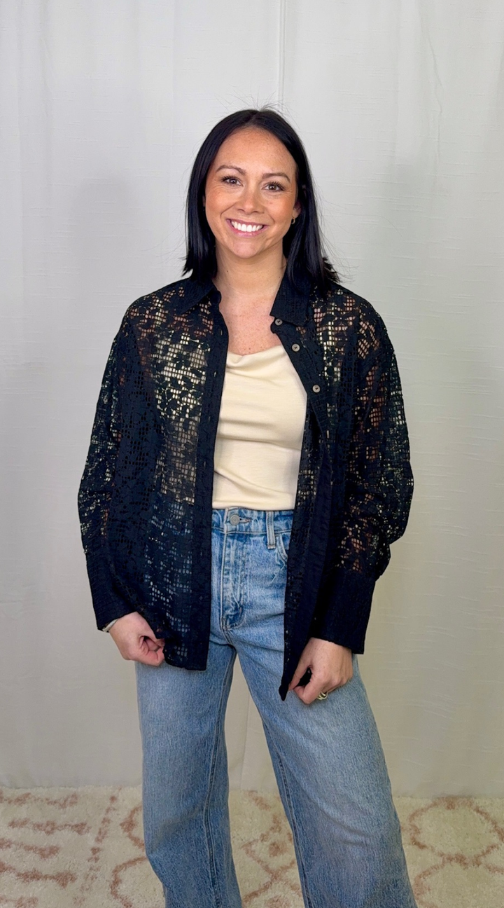 Black lace long sleeve button down top worn with blue jeans