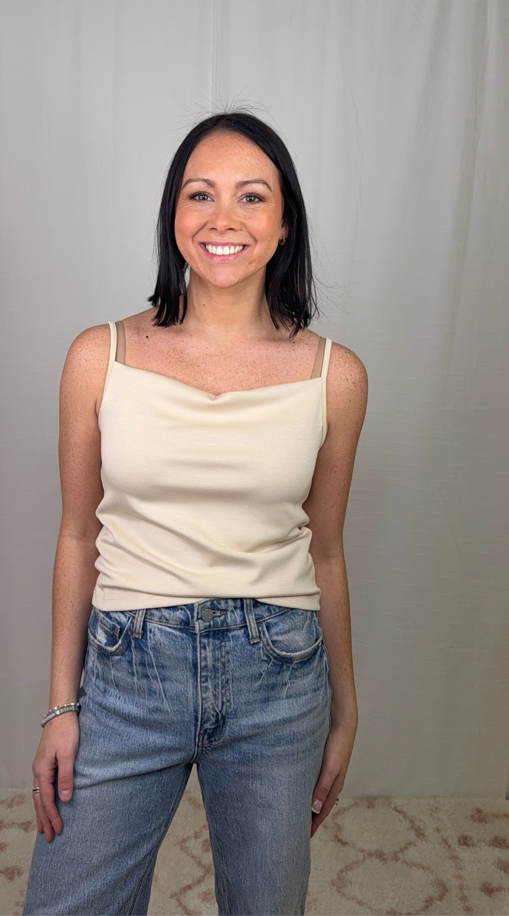Beige modal blend tank top with thin straps worn with blue jeans