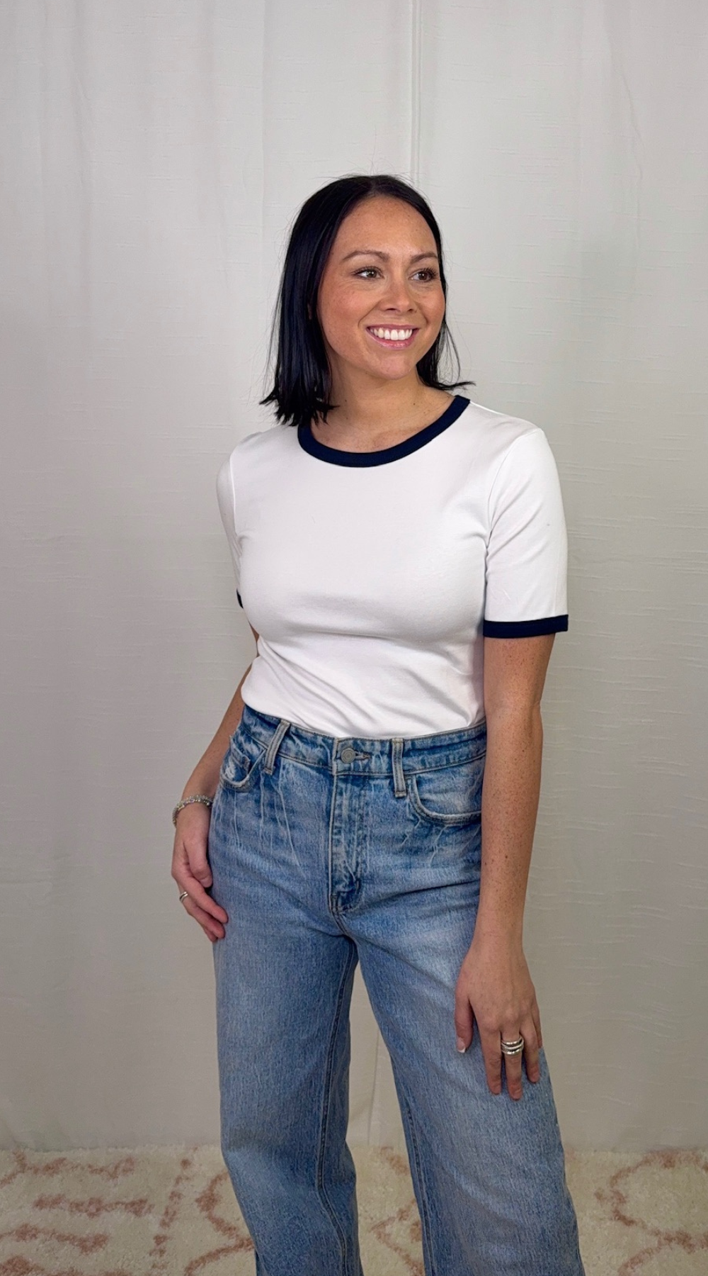 White and navy contrast trim cotton top worn with blue jeans