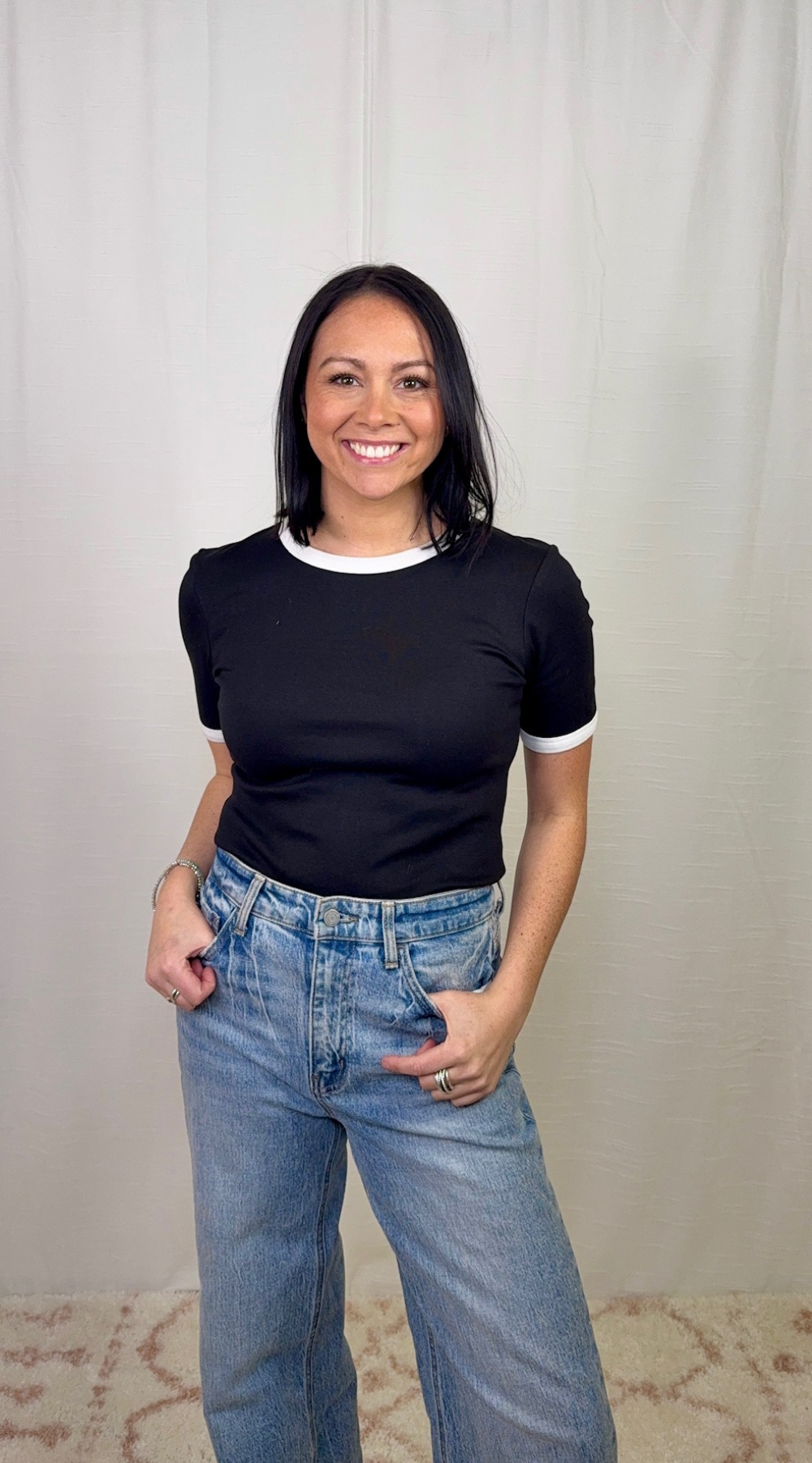 Black and white contrast trim cotton top worn with blue jeans