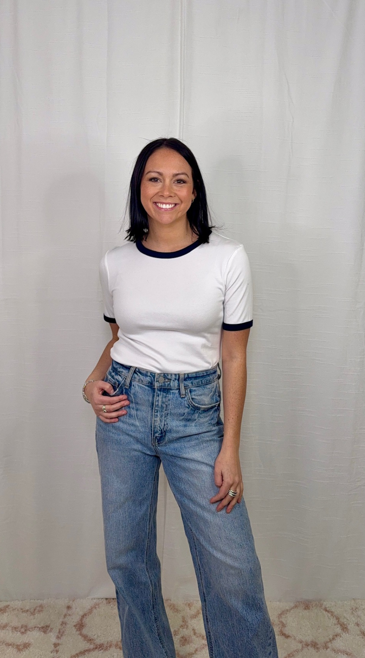 white and navy contrast cotton top worn with blue jeans